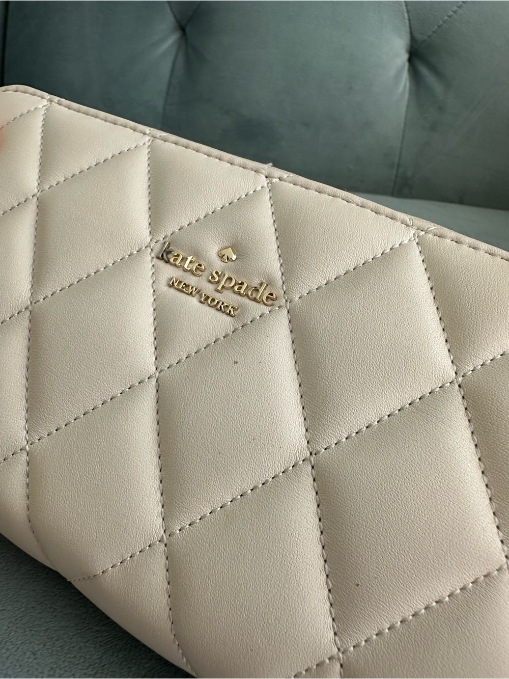 kate spade cream quilted leather wallet with gold logo